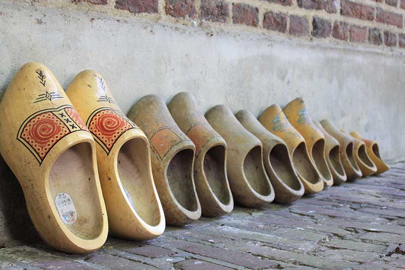 Collection of bridge money with a wooden shoe